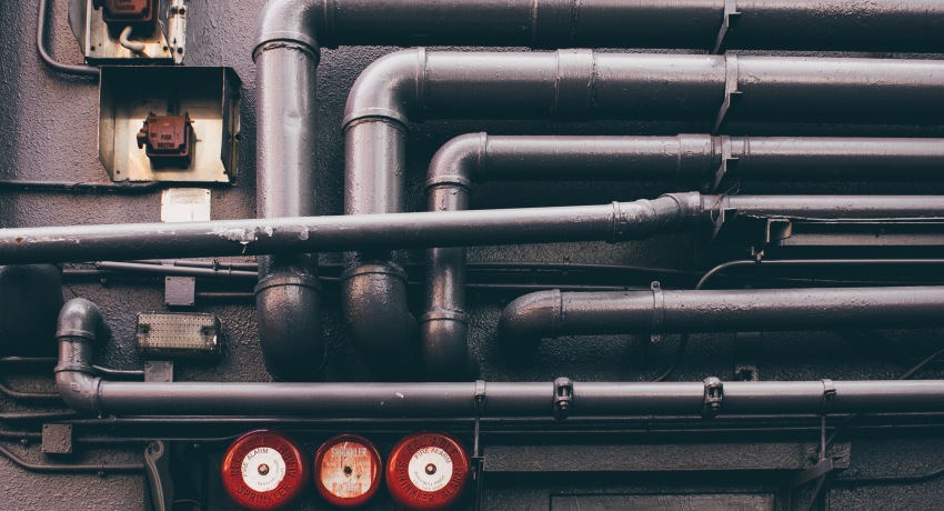 Wall of industrial plumbing pipes